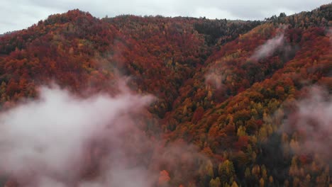 Aerial-fly-through-clouds-of-a-hill-covered