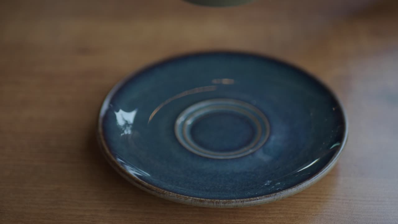 Empty coffee saucer on wooden table
