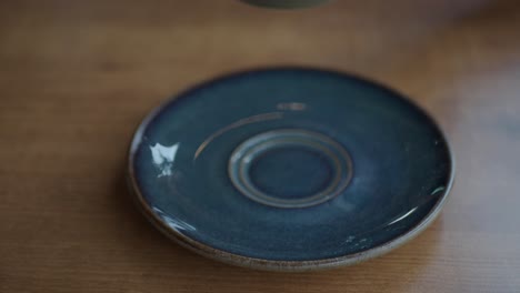 empty coffee saucer on wooden table