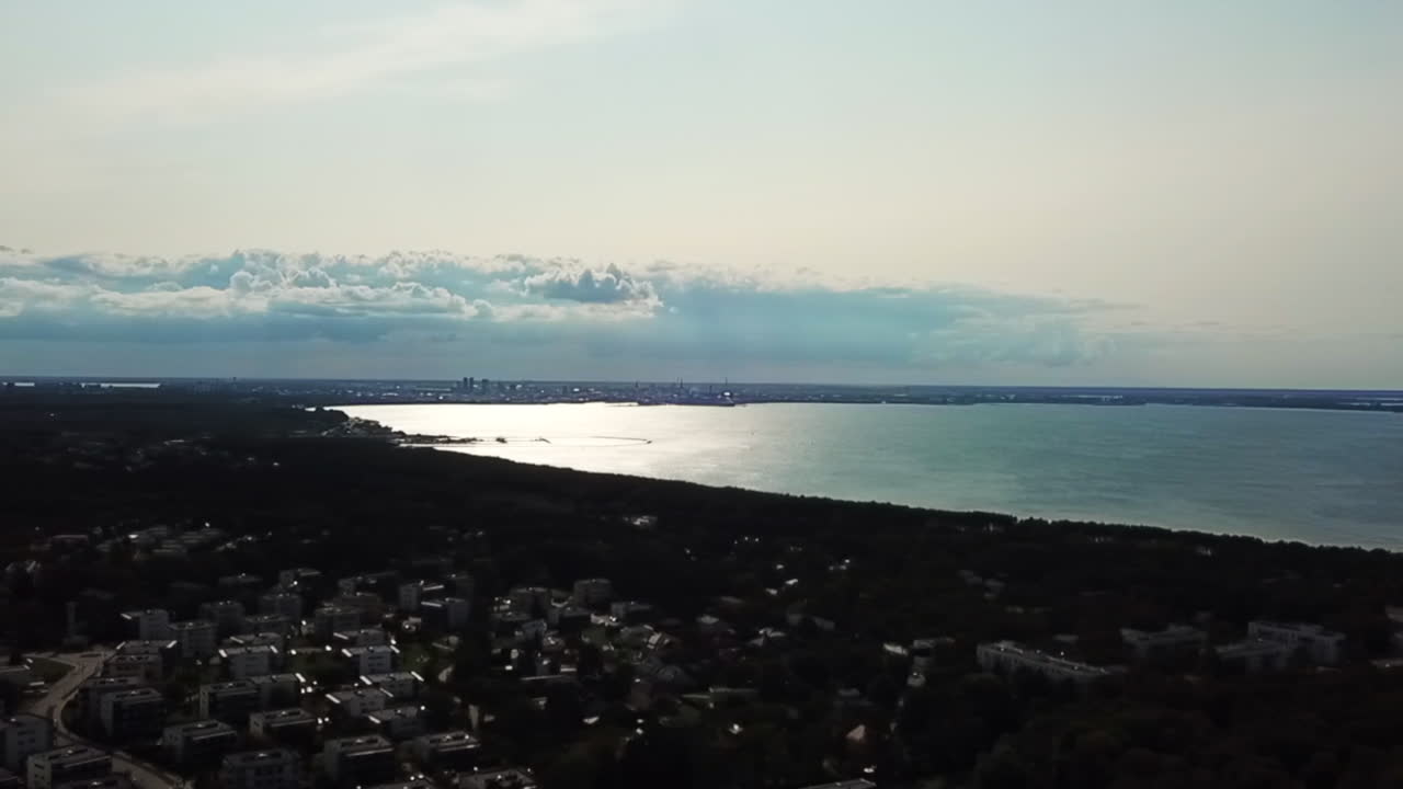 dolly in forward shot above the city of talinn suburb pirita and the sea 2018, aerial view