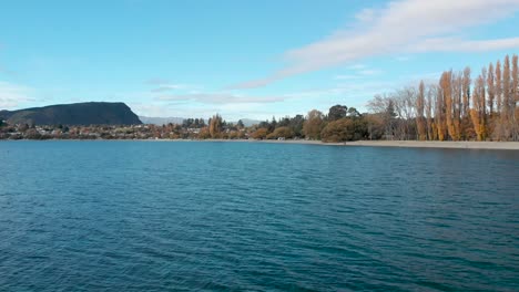 Slowmo-Aerial-Drone-beautiful-blue-lake-and-sky-in-Lake-Wanaka,-New-Zealand-in-autumn