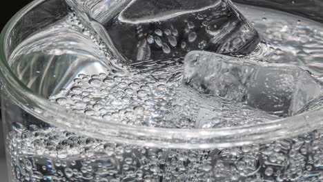 glass of water with ice on a dark blue background