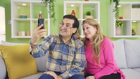 man and woman making mobile video call in virtual app with smartphone in hand.