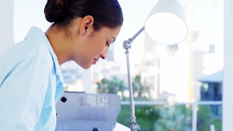 Woman-drawing-design-at-desk