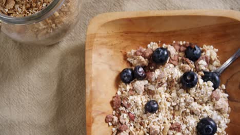 Jar-and-bowl-of-breakfast-cereals-with-spoon-4k