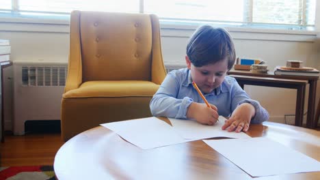 Boy-doing-homework-in-living-room-4k