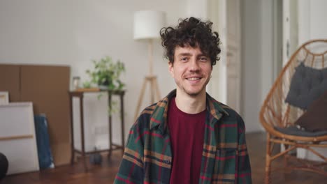 smiling man in a plaid shirt