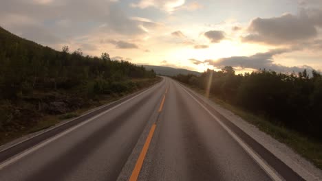 driving a car on a road in norway at dawn