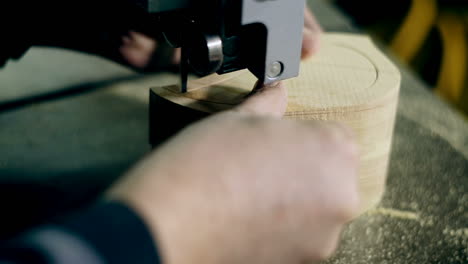 Man Uses An Electric Saw To Cut Wooden Planks. Carpenter is sawing a wooden plank with jig saw machine in carpentry workshop