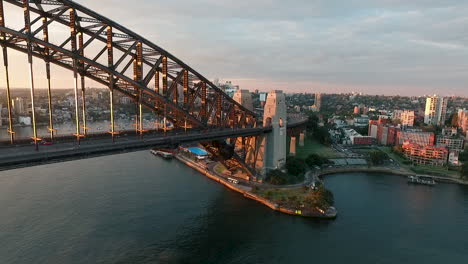aerial forward dolly towards sydney harbour bridge, kirribilli, north sydney at sunset