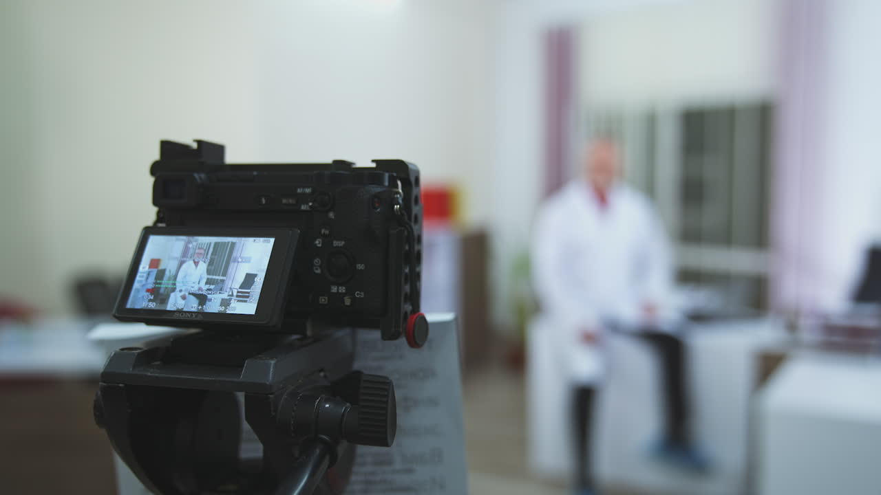 Doctor looking at camera. Male doctor works talking video call