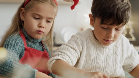 handheld video of children cutting out gingerbread cookies