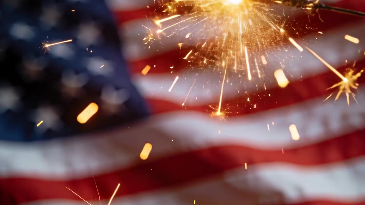 Lighting sparkler sending golden sparks at upper-right of blurred American flag, July, copy space