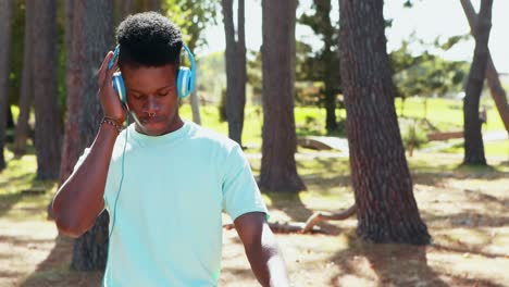 man with headphones riding bicycle in the park 4k