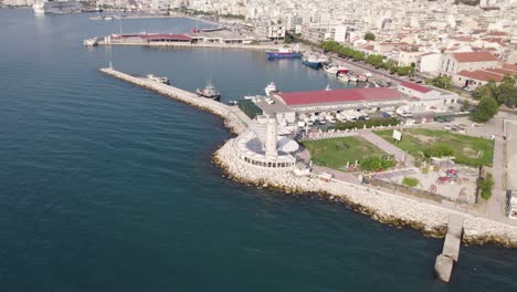 High-angle-drone-view-of-Patras-lighthouse-close-to-old-port,-Greece