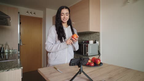 woman making video about cooking in kitchen