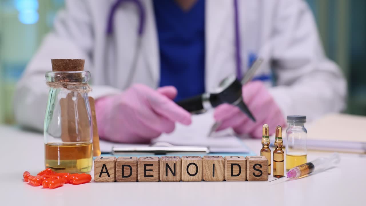 Wooden blocks spell adenoids near vials and medical tools