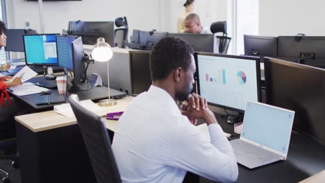 Group-of-diverse-business-people-using-computer-and-walking-in-office,-slow-motion