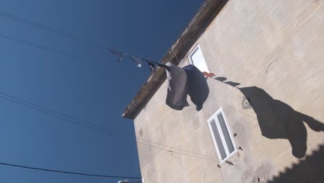 Life-is-going-on-in-Zadar,-Croatia-with-summer-blue-sky-and-clothesline-on-summer-breeze