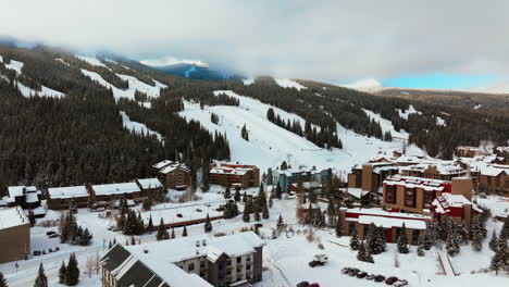 fog lift cloud layer winter snowy early morning sunrise aerial drone copper mountain colorado ski resort i70 eagle flyer lift center village snowboarding half pipe ikon epic pass parking lot upward