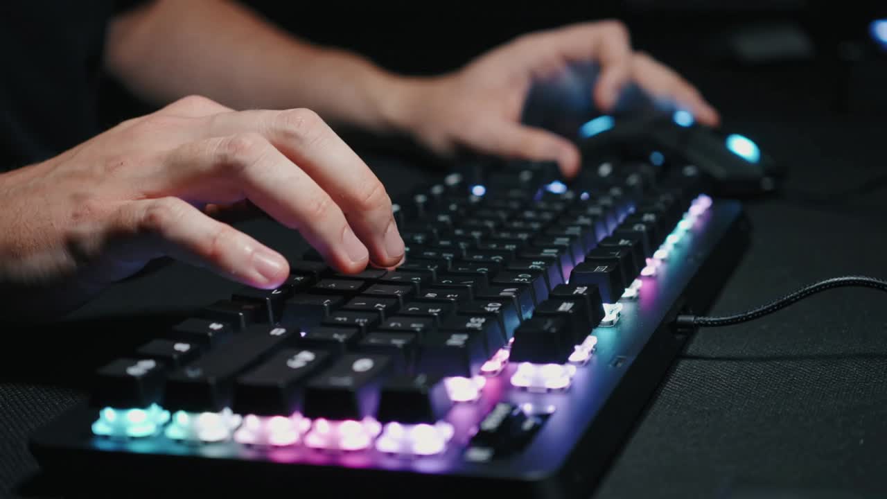Reacting to RGB, hands in short-sleeve shirt pressing mech keyboard and clicking RGB mouse at desk