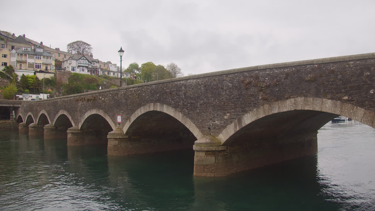 Lateral View Of Ancient Looe Harbour Bridge Across The River Looe In Cornwall, UK. static