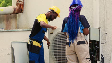 coworkers opening up faulty hvac system