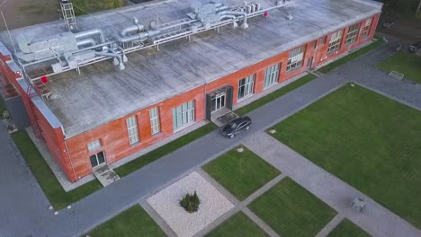 aerial view of industrial building with landscaping