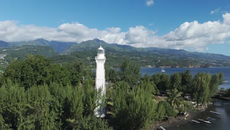 point venus lighthouse and green trees in mahina, tahiti island in french polynesia. - aerial shot