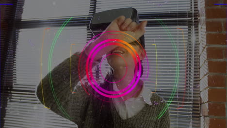 light trails over scope scanner against asian woman gesturing while wearing vr headset at office