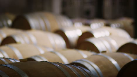 rows of barrels in a modern wine factory warehouse