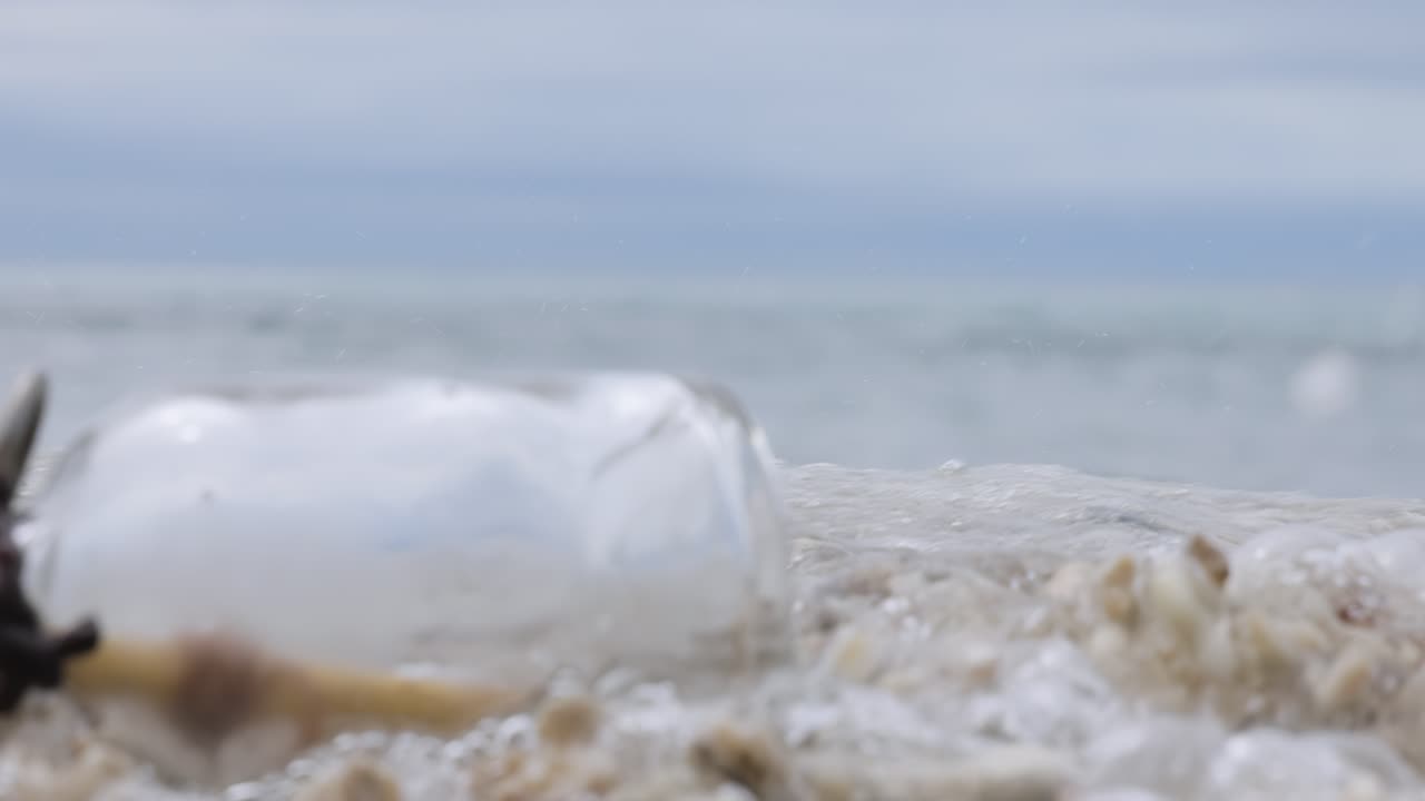 Message in the bottle on a sand beach