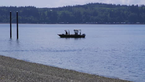 small, nondescript fishing floating near dock at camano island state park, wa state