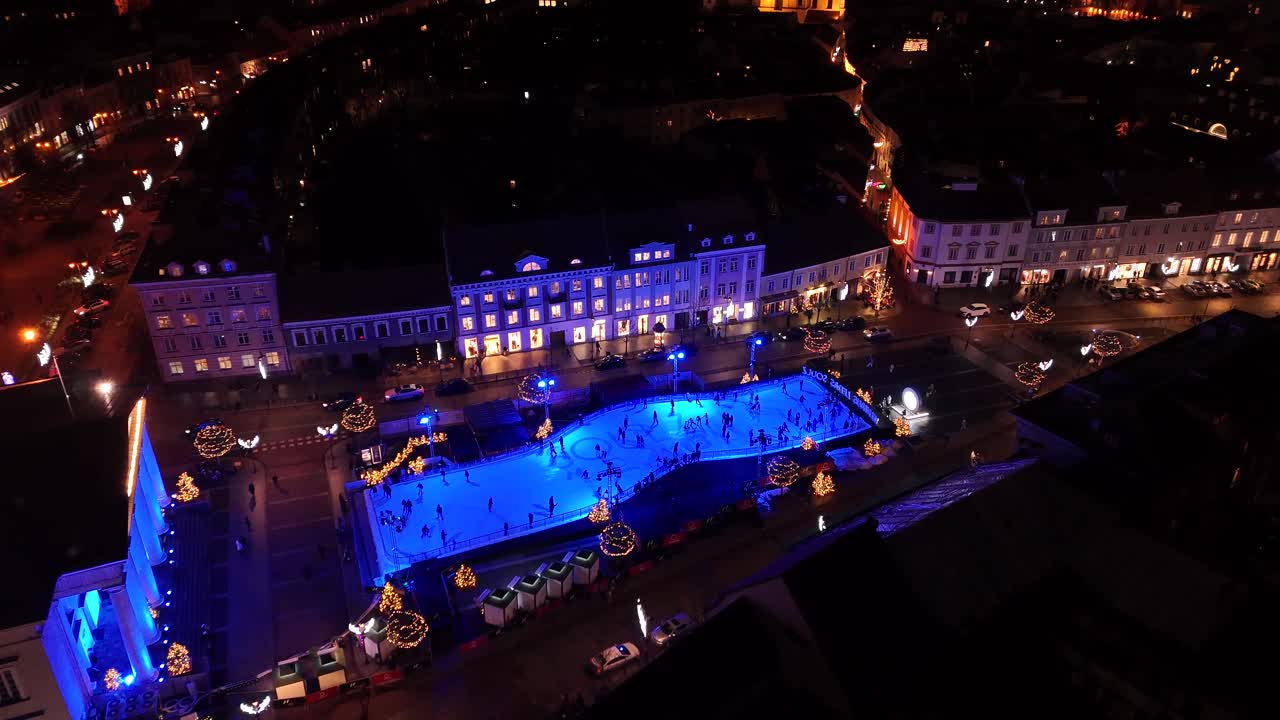 Nighttime aerial view of an ice rink in Vilnius, Lithuania during their Christmas market holiday season