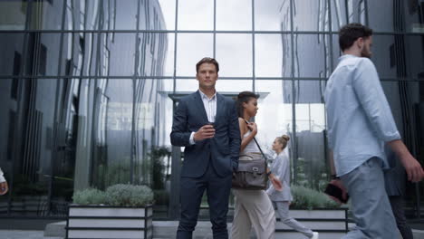 businessman holding coffee cup on downtown street. successful business people.