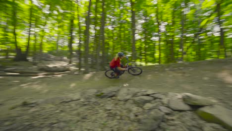 a rider flies through a berm and jumps out and then proceeds to whip the next jump.