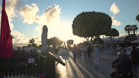 sunset view of a pedestrian street with people walking