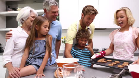 mother serving freshly baked cookies to her extended family