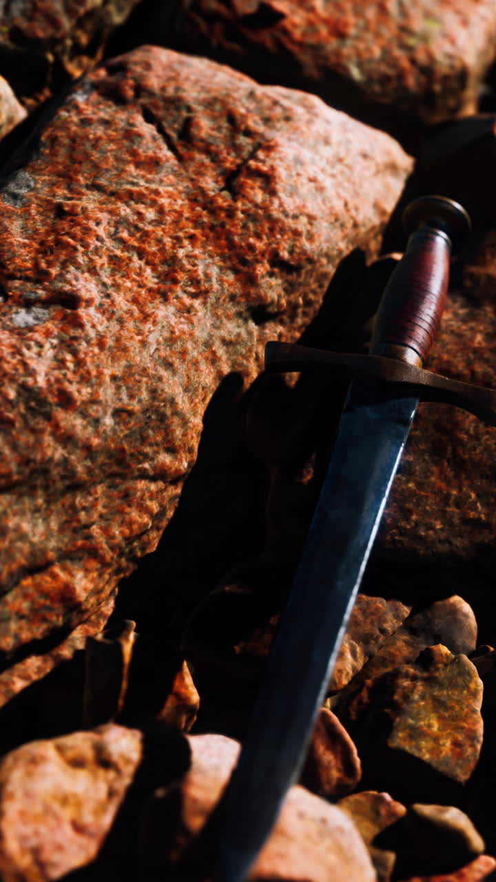 Old dagger on the rock at sunset