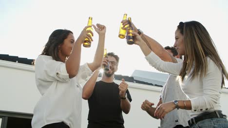 Smiling-friends-dancing-and-clinking-bottles