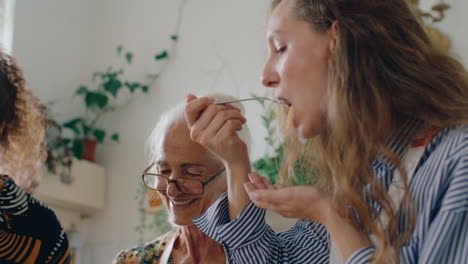 family enjoying homemade pasta cooked by cheerful grandmother