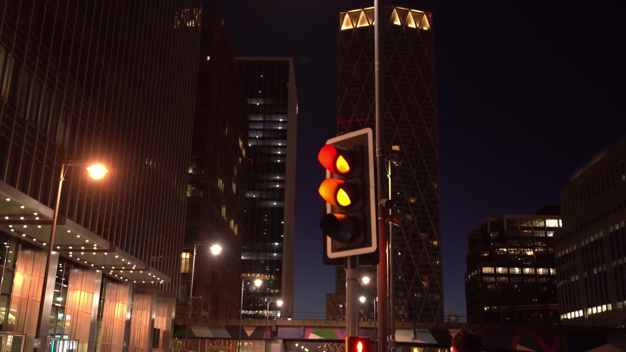 Bank Street at night in Canary Wharf, London, England, wide shot pan left