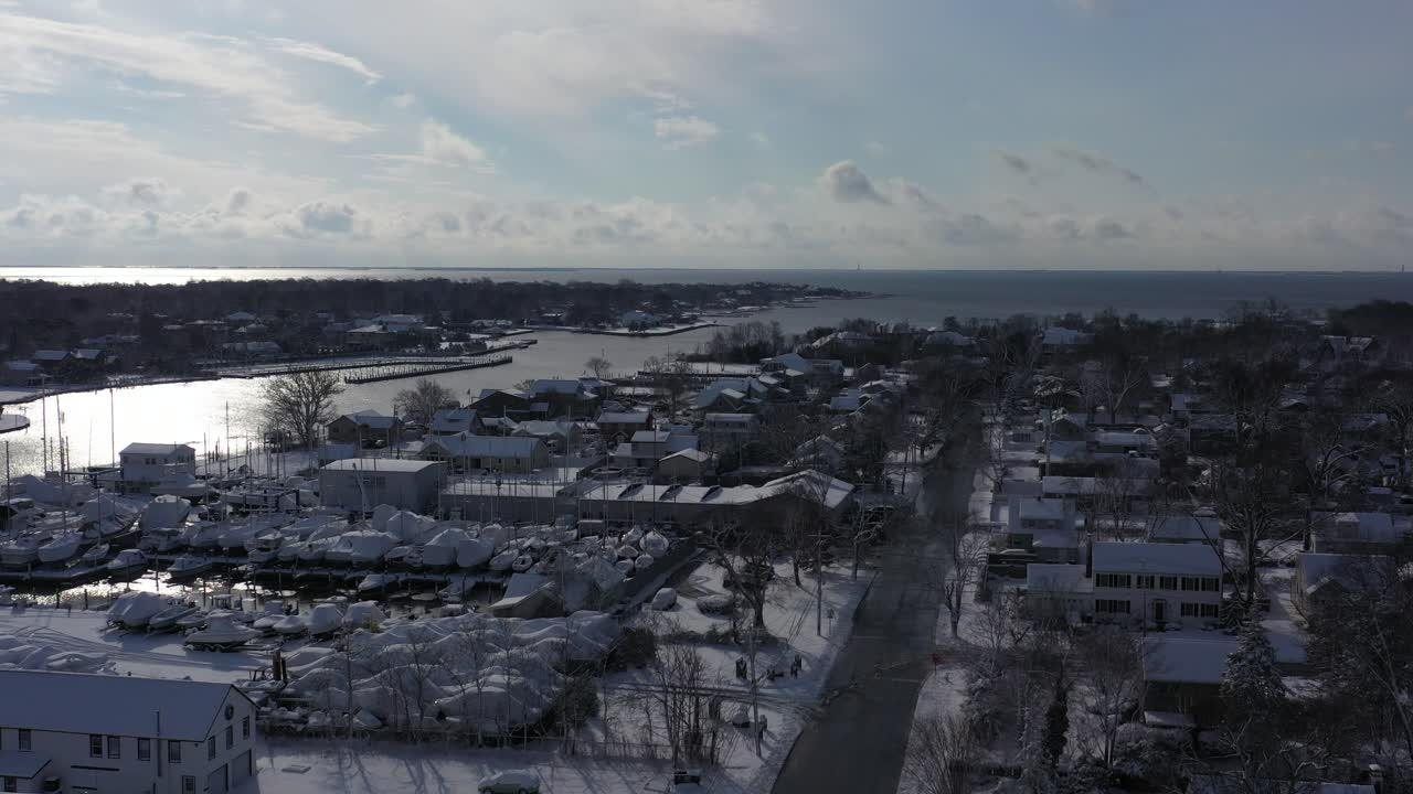 An aerial drone view over Bay Shore, NY, on a bright day after a recent snowfall