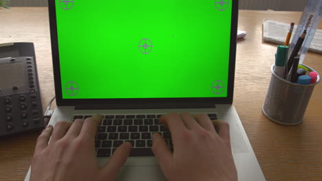 close up of businessperson using laptop with green screen