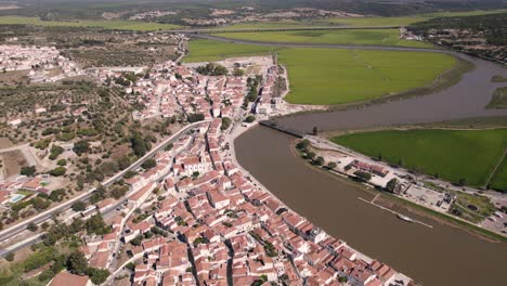 vista panorámica del paisaje urbano de la parroquia junto al río y los campos de arroz junto al canal del río sado