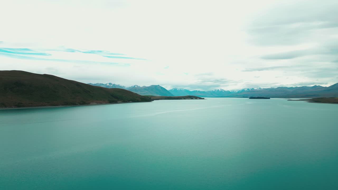 Jezero Tekapo na Novém Zélandu, filmový záběr dronem nad tyrkysově modrou vodou