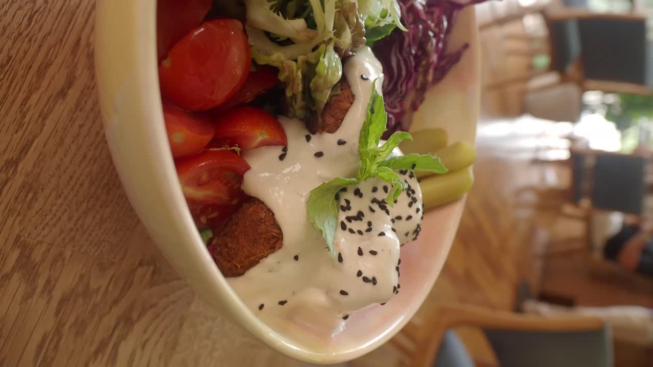 Delicious Falafel Bowl with Fresh Salad and Tahini Sauce