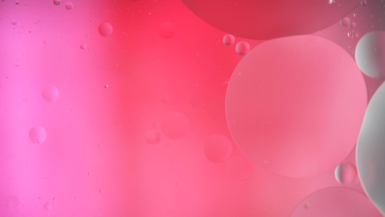 Fantastic structure of colorful bubbles. Chaotic motion. Abstract colorful paint. Top view. Movement of bubbles in the liquid. Oil surface multicolored background. Macro