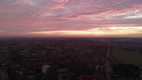 birds fly by drone at sunset over downtown