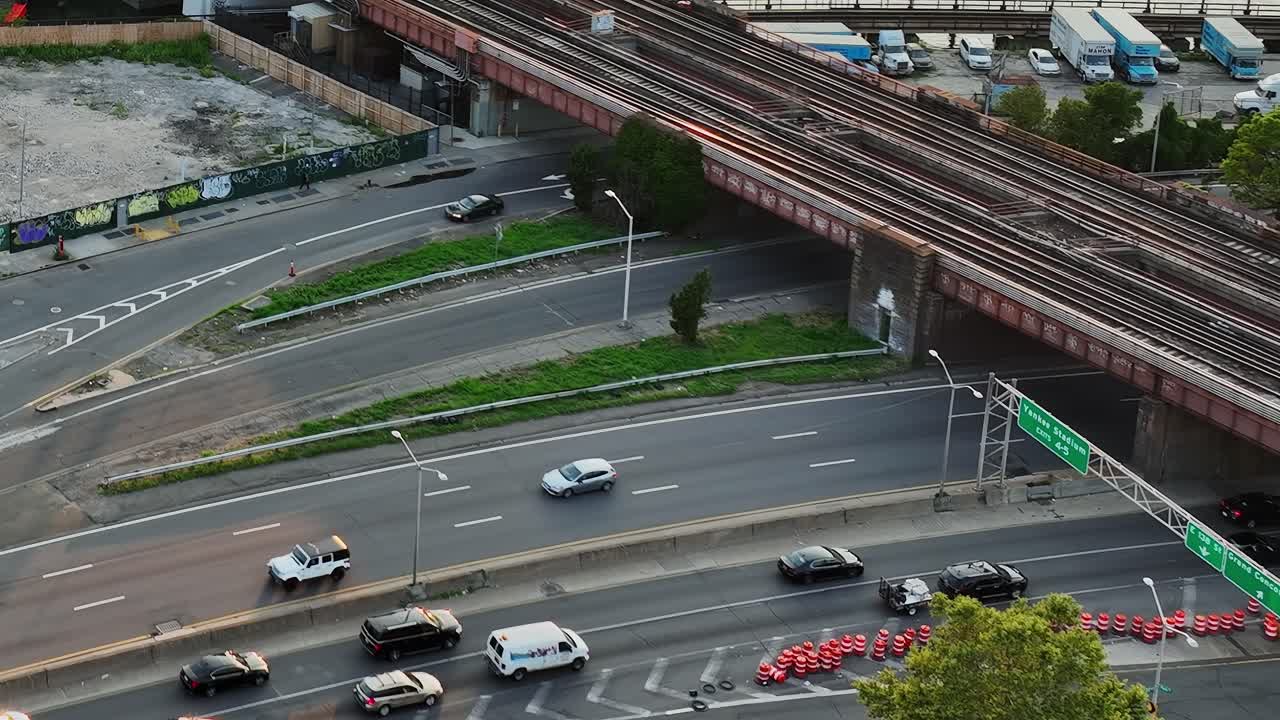 Traffic winding through New York streets with rail tracks above